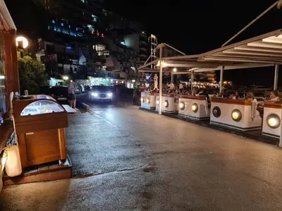 a street at night with a train with people on it at Top floor with stunning seaview, first line in Rafailovici