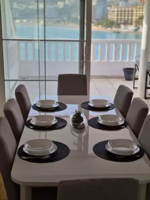 a table with chairs and plates on top of it at Top floor with stunning seaview, first line in Rafailovici