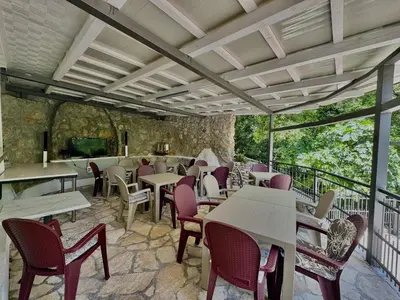 a restaurant with tables and chairs on a balcony at FOR-A Apartmani in Becici