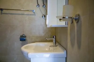 a bathroom with a sink and a toilet at FOR-A Apartmani in Becici