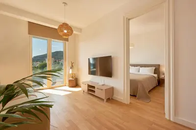 a bedroom with a bed and a tv and a mirror at Skyline resort in Becici