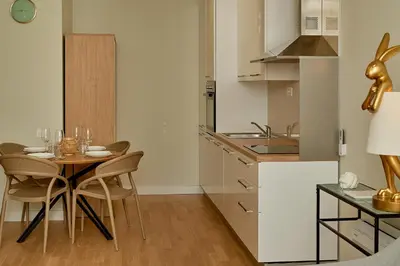 a kitchen with a table and chairs in a room at Skyline resort in Becici