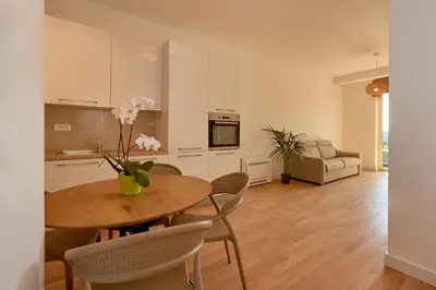 a kitchen and dining room with a table and chairs at Skyline resort in Becici