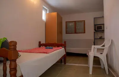 a small bedroom with a bed and a chair at Villa Horizon Canj in Čanj