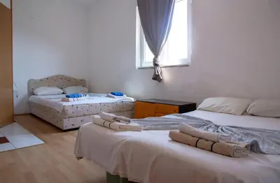 a bedroom with two beds and a window at Villa Horizon Canj in Čanj