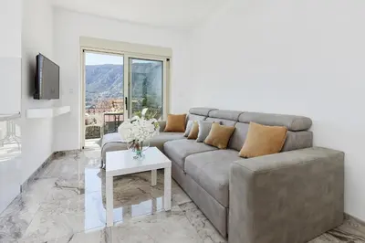 a living room with a couch and a table at Stanisic Family Apartments in Kotor