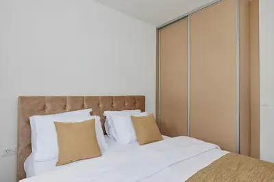 a bedroom with a large white bed with white pillows at Stanisic Family Apartments in Kotor