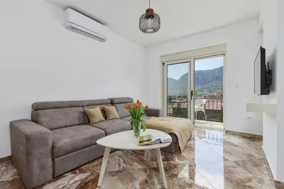 a living room with a couch and a table at Stanisic Family Apartments in Kotor