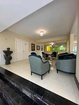 a living room with two couches and a table at Vile Oliva Hotel & Resort in Petrovac na Moru
