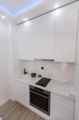 a white kitchen with white cabinets and a sink at Luxury apartment Casa Al Mare in Rafailovici