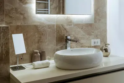 a white sink sitting on a counter in a bathroom at Cape Montenegro Villas in Krimovice