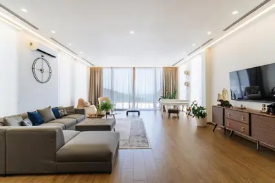a large living room with a couch and a tv at Cape Montenegro Villas in Krimovice