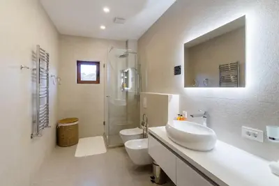 a bathroom with a sink and a toilet and a shower at Cape Montenegro Villas in Krimovice