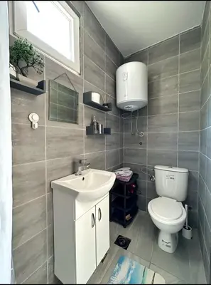 a bathroom with a toilet and a sink at JG Studio apartment in Vranjina