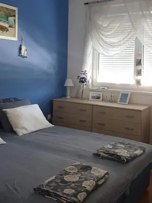 a bedroom with a large bed with a window at Meri in Bar