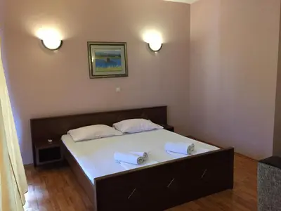 a bedroom with a bed with two towels on it at Firenze Apartments in Ulcinj