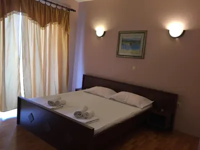 a bedroom with a bed with two towels on it at Firenze Apartments in Ulcinj