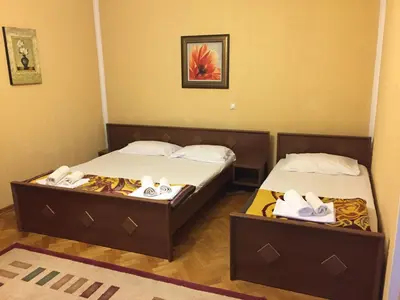 two beds in a hotel room with towels on them at Firenze Apartments in Ulcinj