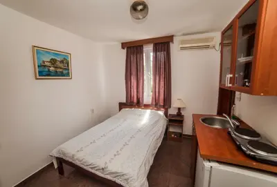 a small room with a bed and a sink at Mijovic Apartments in Budva