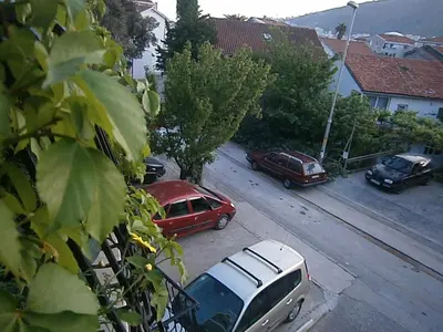 a group of cars parked on the side of a street at Mijovic Apartments in Budva