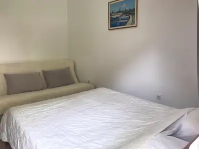 a bed and a couch in a room at Mijovic Apartments in Budva