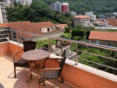 a table and chairs on a balcony with a view at Hotel Stella di Mare in Budva