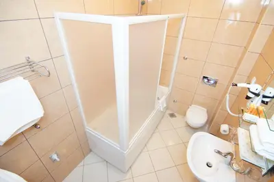 a small bathroom with a toilet and a sink at Hotel Stella di Mare in Budva