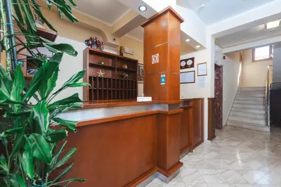 a waiting area of a law clerks office with a potted plant at Hotel Stella di Mare in Budva