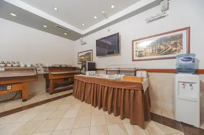 a salon with ping pong tables and a tv at Hotel Stella di Mare in Budva