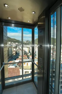 an elevator in a building with a view of a city at Apartments Lux in Budva