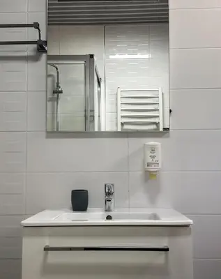 a bathroom with a sink and a mirror at Paradise beachfront view 1 in Bar