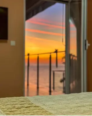 a view of the ocean from a room with a bed at Paradise beachfront view 1 in Bar