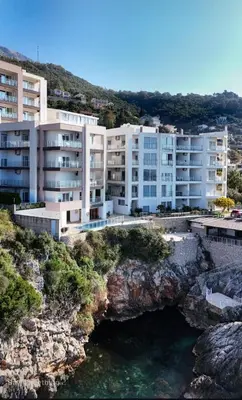 an apartment building on a cliff next to the water at Paradise beachfront view 1 in Bar