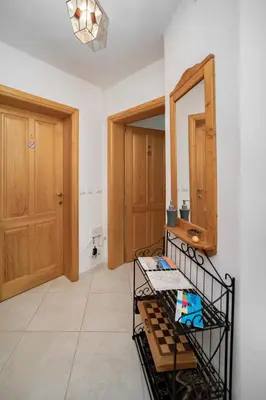 a room with a mirror and a shelf with towels at Villa Katharina in Utjeha