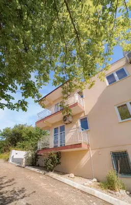 a building with balconies and trees at Villa Katharina in Utjeha