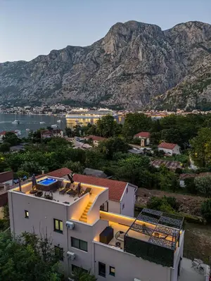 a view of a building with a mountain in the background at Marea DeLuxe Apartments in Kotor