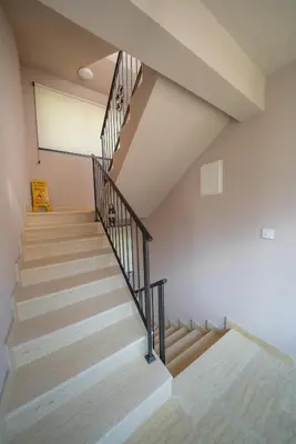 a staircase in a house with wooden stairs at Marea DeLuxe Apartments in Kotor
