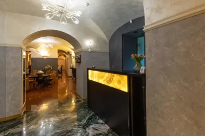 a living room with a hallway with a table at Hotel Vardar in Kotor