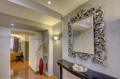 a large mirror on the wall of a bathroom at Hotel Vardar in Kotor