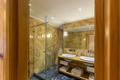 a bathroom with two sinks and a shower at Hotel Vardar in Kotor