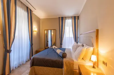 a hotel room with a bed and a window at Hotel Vardar in Kotor