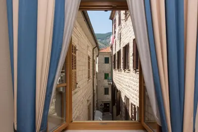 a window view of an alley from a building at Hotel Vardar in Kotor