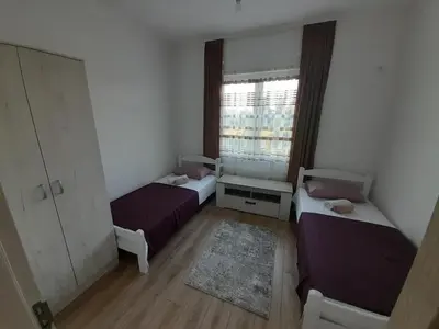 a small room with two beds and a window at Apartment Long beach in Ulcinj