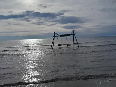a swing in the water on a beach at Apartment Long beach in Ulcinj