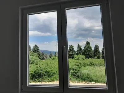 a window with a view of a green field at Apartment Long beach in Ulcinj