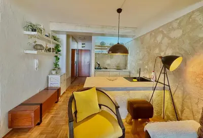 a living room with a bed and a kitchen at Sea view Studio Terminal in Budva