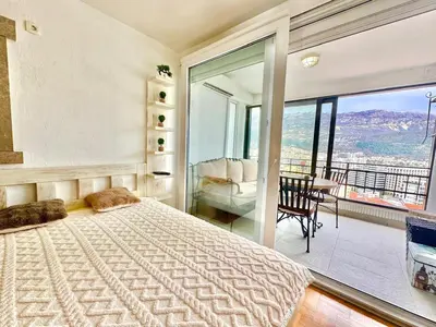 a bedroom with a bed and a balcony at Sea view Studio Terminal in Budva