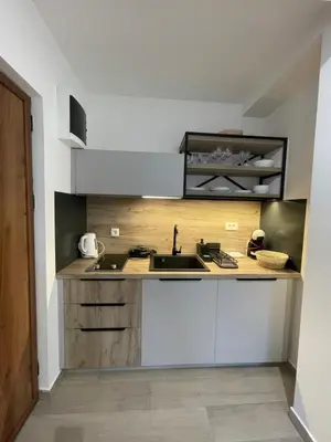 a kitchen with a sink and a counter at Dora Family Apartments Budva in Budva