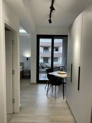 a kitchen and dining room with a table and chairs at Dora Family Apartments Budva in Budva