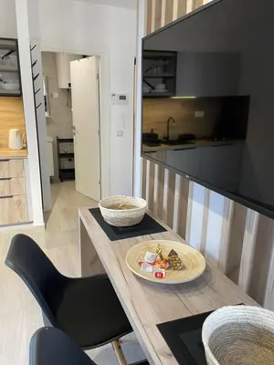 a kitchen with a table with a plate of food on it at Dora Family Apartments Budva in Budva